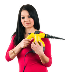 Young housewife prepares a steam cleaner to clean