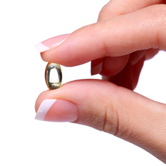Capsule of Vitamin A in Female Hand. Fish Oil or Omega-3 Pills.