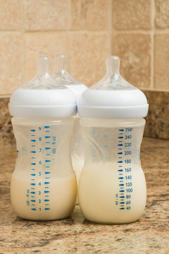 Prepared infant forumla in bottles on kitchen counter