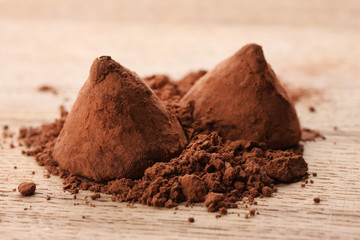 Chocolate truffles and cocoa, on wooden background