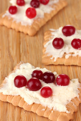 Cookie with cheese and cranberry, on wooden background