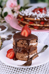 Fototapeta na wymiar Chocolate cake with strawberry on wooden table close-up