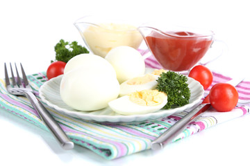 Boiled eggs on plate on napkin isolated on white