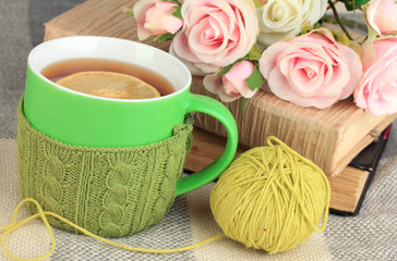 Cup of tea with knitted thing on it close up