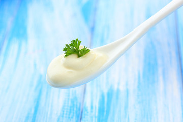 Sour cream in spoon close-up
