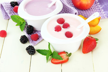 Delicious yogurt with fruit and berries on table close-up