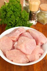Raw turkey meat on wooden table close up
