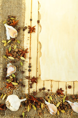 Herbs and spices border, on wooden background