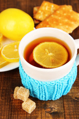 Cup of tea with lemon on wooden table