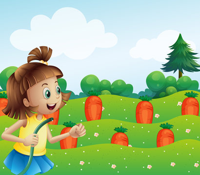 A happy girl watering the carrots in the farm