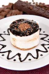 Sweet cake with chocolate on plate on table close-up