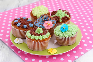 Tasty cupcakes with butter cream,
