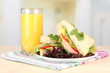 Fresh and tasty sandwiches on plate on table on light