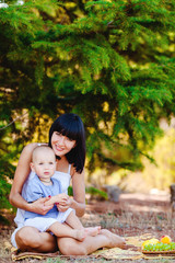 Young mother with child outside on a summer day