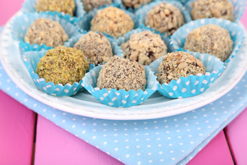 Set of chocolate candies, on wooden background