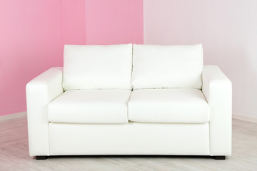 White sofa in room on pink wall background