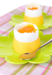 Boiled eggs in egg cups on table close-up