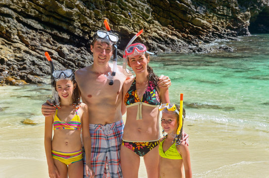 Happy family snorkeling and having fun on beach vacation - Powered by Adobe