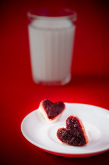 sandwiches with lingonberry jam in the form of hearts on a platt