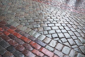 Background texture of wet granite cobblestone urban road