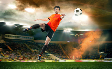 football player striking the ball at the stadium