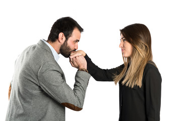 man kissing a woman's hand over white background.