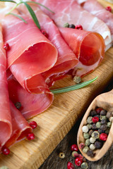 sliced prosciutto on a wooden board