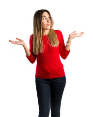 Cute young girl having doubts over isolated white background