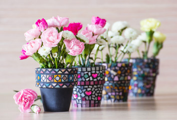 Fototapeta na wymiar Carnation in mosaic flower pot