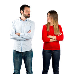 Couple with their arms crossed over isolated background