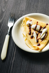 Closeup of chocolate pancakes with whipped cream