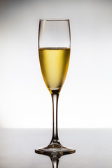 empty glasses of champagne and one being filled 