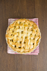 Apple pie on gingham towel, cooked
