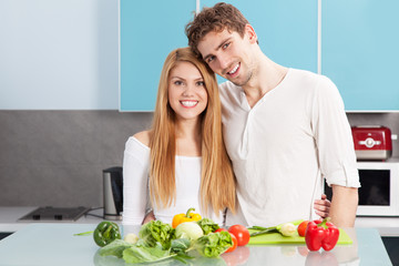 Young beautiful couple cooking at home