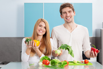 Young beautiful couple cooking at home