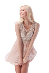 Sexy blonde woman posing with wind in the hair and dress