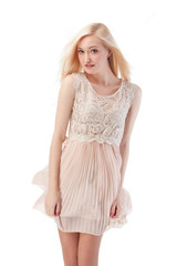 Sexy blonde woman posing with wind in the hair and dress