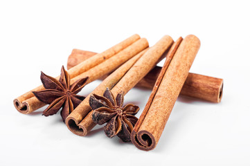 Cinnamon, anise and cloves on white background