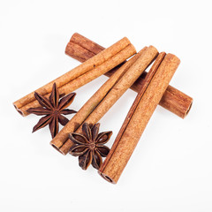 Cinnamon, anise and cloves on white background