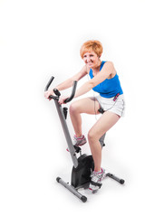 Fototapeta na wymiar Woman doing sports on exercise bike