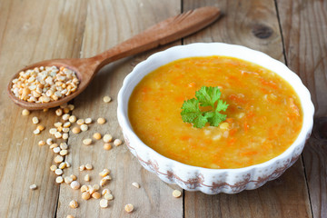 Pea soup on wooden table