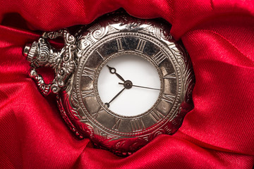 Vintage Pocket Mechanical Watch On Red Satin Background