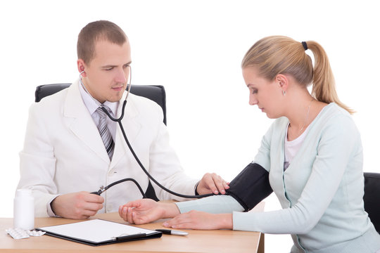 young doctor measuring blood pressure of patient in office isola