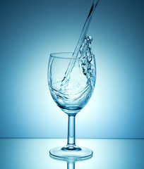 white wine pouring on blue background