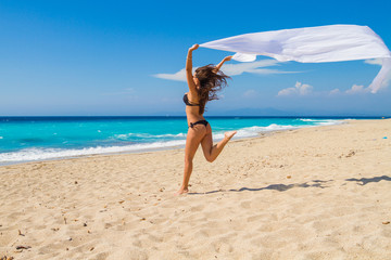 Beautiful Girl With White fabric on The Beach.