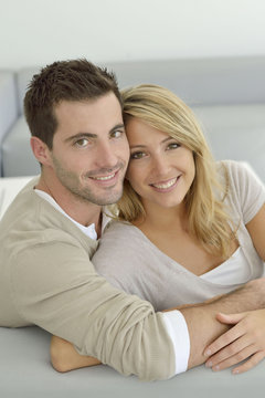 Upper view of sweet couple embracing in sofa