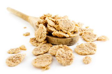 Corn flakes and wooden spoon isolated on white