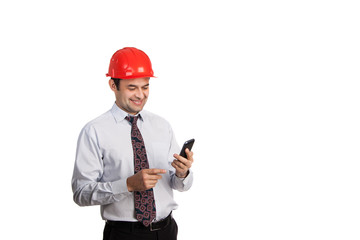 engineer in a red helmet with a mobile phone