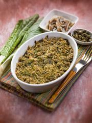 gratin of swiss chard anchovies and capers, selective focus