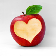 Plakat Red apple with a heart shaped cut-out.